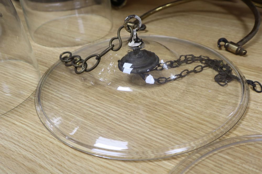 Two glass hurricane ceiling lamps